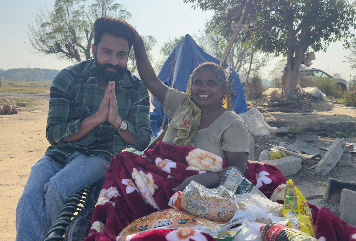 Elderly grandmother placing hand on founder head with blessing and warm blankets