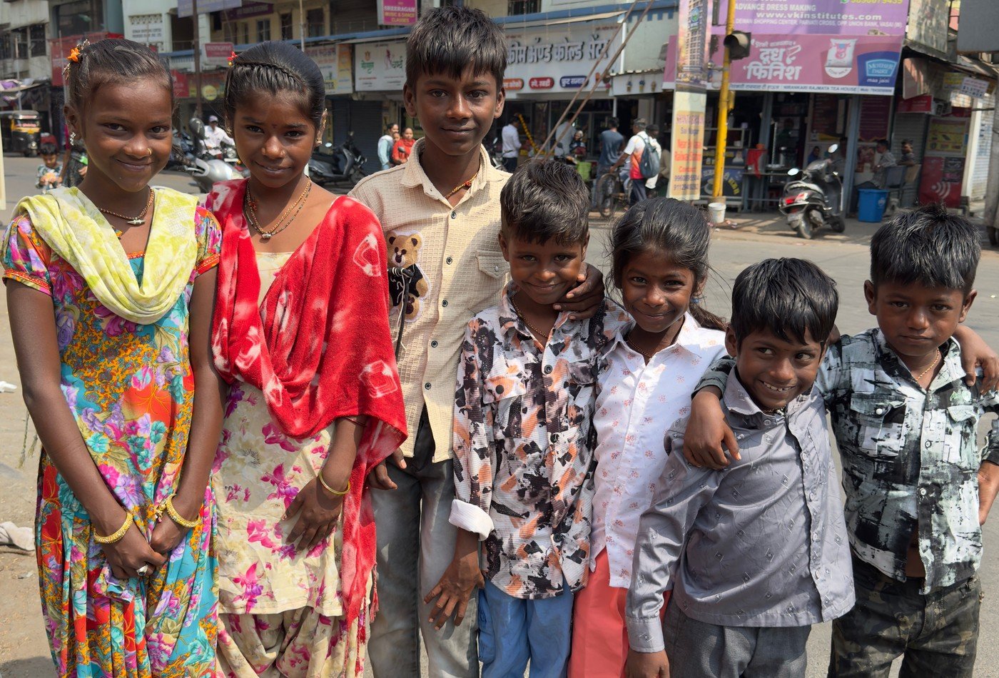 Underprivileged children smiling with brand-new footwear and school dignity kits